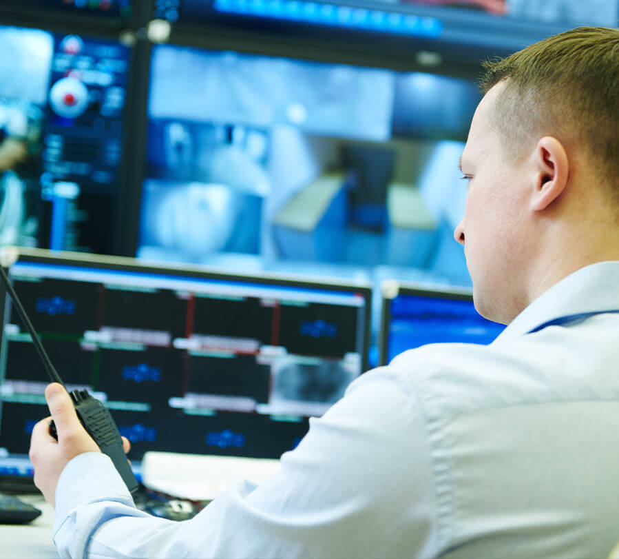 Security guard monitoring security cameras